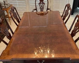 Dining Room: The HENREDON "Rittenhouse Square" dining table is now shown without the china.  It does include eight chairs (two arm and six side).  The table has a banded top as shown and measures 76" x 46" without the leaves.   Two 24" leaves and custom table pads are included in the price of the set. There is a single felt-lined drawer at each end . The next photos show some details of the table as well as a close-up of one of the dining chairs.