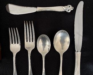 Living Room:  This is the perfect set of STERLING flatware for the orchid lover in your life.  It is "Orchid Elegance" by WALLACE and includes:    8 Dinner Forks;  8  Salad Forks;  8 Teaspoons; 6  Soup Spoons;  2   Cocktail Forks; 2  Miscellaneous Spoons; 11 Butter Knives; and 12 Dinner Knives, for a total of 57 pieces. 
A flatware chest is included.