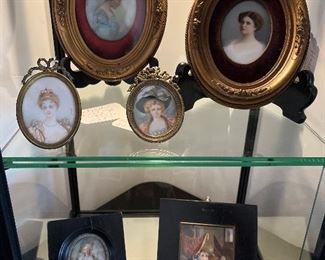 Living Room:  A second small case displays more framed small portraits. 