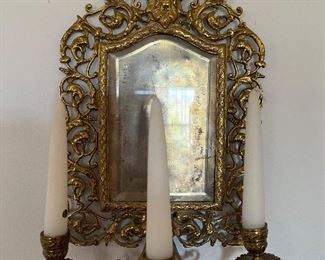 Living Room:  An antique brass wall mirror/sconce has the head of the Greek god Bacchus at the top.  Bacchus is the god of wine and pleasure.
