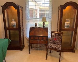 Bedroom #1:  Matching lighted curio cabinets with glass shelves flank an antique drop-front desk.  A closer photo of one of the curio cabinets follows.  The lyre back chair and decorative items are also for sale.