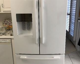 Kitchen:  The WHIRLPOOL "Gold" French door refrigerator with lower freezer is from 2011.  It has an ice and water dispenser as well. Its measurements are 70-1/8" x  35-5/8"  x 35-1/4."