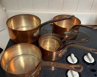 Kitchen:  A set of vintage copper cookware includes six pieces.
