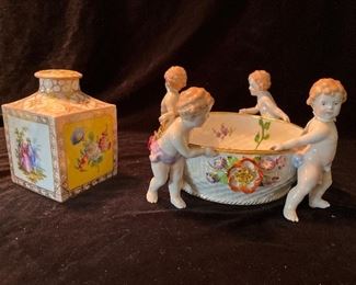 Living Room:  A 5-1/2" tall DRESDEN porcelain tea caddy has four different scenes.  The SCHIERHOLZ porcelain bowl with four cherubs is darling but has repairs.