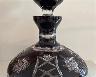 Living Room:  A large deep red Romanian decanter has clear cut designs.