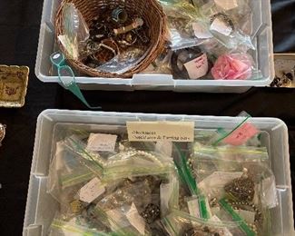 Living Room:  Two containers are filled with bagged costume jewelry and novelty watches.  There are over 185 bags!