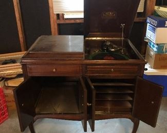 Hall:  This VICTOR Victrola was introduced in 1923 when 102,500 of them were manufactured, so this could be your last chance! It is model VV-215; Serial Number 15080.  It is a flat-top console and includes a phonograph and storage for records, as shown.