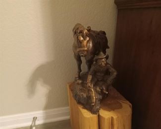Metal bronzed cowboy and horse statue
