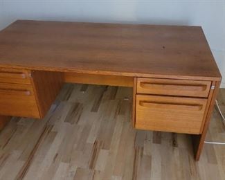 Danish modern desk with natural teak finish, clean modern lines, and carved wood drawer pulls. Spacious double set of removable drawers offers office and filing storage. Finished back makes this suitable for use in the center of an office. Matching side table included. Like new, original owner non smoker / no pets. Overall Dimensions: Width: 72 inches, Height: 29 inches, Depth: 36 inches. Make an offer.