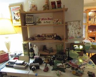 Lot's of cool treasures including a 2 sided White Rock sign, transistor radios, camera, Winston Churchill by Royal Doulton and more