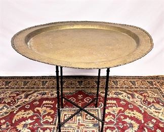 Large hand crafted brass tray from Hong Kong with folding faux rattan base. ........To register and to place bids simply go to www.capitolsalesservices.hibid.com