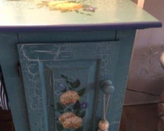 Charming blue cabinet, handpainted with hydrangeas and crackling, one adjustable shelf. Great condition. Now $60.