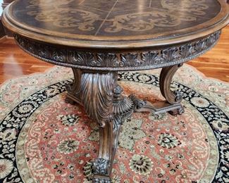 Carved Round Foyer Table with Metal Inlay and Scalloped Rug
