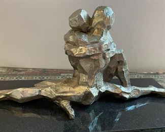 Metal sculpture of couple embracing
