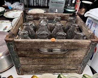 lot of milk bottles and wooden crate 
