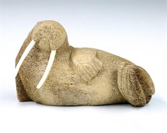 Ron "Qay" Apangalook, American/Yupik (St. Lawrence Island), b. 1968.  A contemporary ossified bone carving depicting a Walrus with inlaid Bone eyes and tusks.  Signed "QAY" at underside.  Minor wear.  Approx. 8 x 3 1/2 x 5" high overall.  ESTIMATE $300-400
