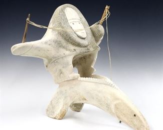 Richard Olanna, American/Inupiaq (Shishmaref), b. 1962.  A contemporary ossified whale vertebrae carving depicting a stylized Inuit fisherman with sinew fishing line.  Initialed "R.O." at base.  Minor wear.  Approx. 18 x 15 x 15" high overall.  ESTIMATE $400-600
