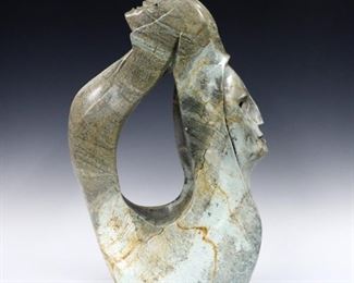 Roy Henry, Canadian/Iroquois, 20th century.  A contemporary variegated Green Soapstone carving depicting a shaman with faces at front and back.  Signed "Roy Henry" and dated "07" towards bottom.  Minor surface wear with some small flakes.  Approx. 14 x 5 x 20" high overall.  ESTIMATE $600-800
