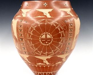 Norman Red Star, Native American/Sioux, b. 1955.  A 20th century Redware pottery vase.  Geometric and figural designs depicting a buffalo hunt using sgraffito technique with inlaid Turquoise accents.  Signed "Red Star, WI-Cahpe-Luza" at underside.  Minor wear, a few tiny holes in design from firing.  13" diameter x 15 1/2" high overall.  ESTIMATE $600-800
