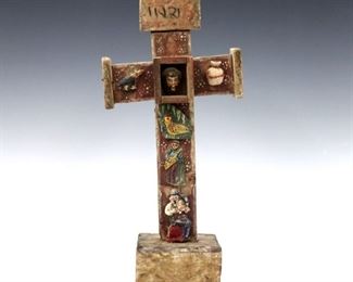 A 19th century Mexican carved wood Cruz de las Animas (Cross of Souls).  Depicts a central framed head of Christ surrounded by carvings of musicians and some Instruments of the Passion including a rooster and pitcher.  Some wear and minor damage, shrinkage.  14" high.  ESTIMATE $300-400
