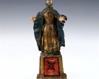 A 19th century Spanish Colonial carved wood Santos figure.  Depicts St. Joseph with polychrome decoration and Gilded detail.  Some wear and minor damage, lacks objects in right hand.  10 1/2" high.  ESTIMATE $300-400
