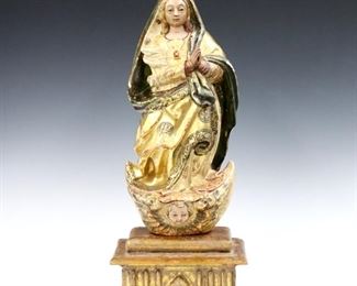 An 18th century Spanish Colonial carved wood Santos figure.  Depicts Our Lady of the Immaculate Conception with polychrome decoration and Gilded detail, on a separate similar stand.  Wear and minor damage, craquelure, some touch-ups.  Figure is 15 3/4" high on a 8 1/2 x 6 1/2 x 4 1/2" high stand.  ESTIMATE $400-600
