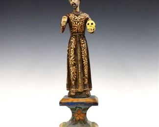 A turn of the century Latin American carved wood Santos figure.  Depicts St. Francis of Assisi with polychrome decoration and Gilded detail.  Some wear, lacks cross in left hand.  18 1/2" high.  ESTIMATE $300-400
