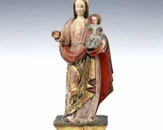A 18th century Spanish Colonial carved wood Santos figure.  Depicts The Madonna and Child with polychrome decoration and Gilded detail.  Some wear and minor damage, shrinkage cracks.  11" high.  ESTIMATE $300-400
