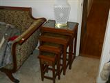 set of four Asian nesting tables, all are carved/with glass tops.