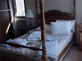four poster queen sized bed goes with five piece bedroom set