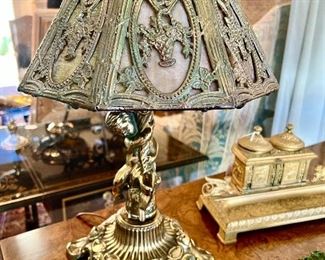 Slag glass desk lamp with cupid.