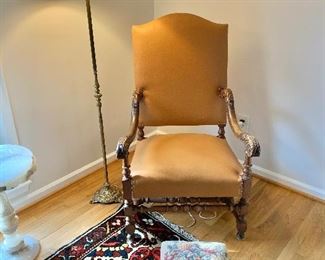 Carved Empire style arm chair upholstered in leather with nail head trim