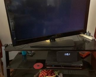 TV 48 inch. A few years old. Works great. Nice TV stand glass shelves. DVD player and Blu-ray.