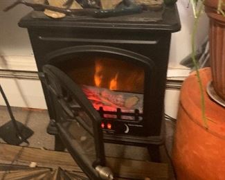 Space heater. Electric wood-burning stove style adjustable heat settings.