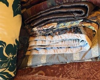 Assorted quilts and bedding