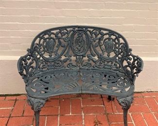 One of two cast iron settees