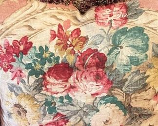 One of two floral fringe-trimmed pillows