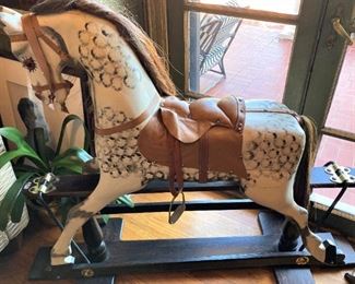 Wooden pony with leather saddle
