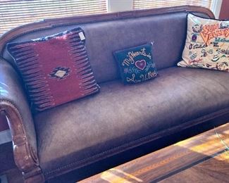 Brown leather sofa with nail-head trim; Sun Valley pillows