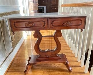 Antique wooden lyre table with marble top. 30"h x 35"w x 14"d. Available for pre-sale starting 1/9/23. Text 615-854-8535 for more information and/or to arrange a time to view.