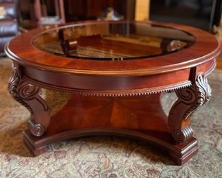 Round wooden coffee table with glass top. 40" diameter x 18" height.  (Has matching side tables and sofa table) Available for pre-sale starting 1/9/23. Text 615-854-8535 for more information and/or to arrange a time to view.