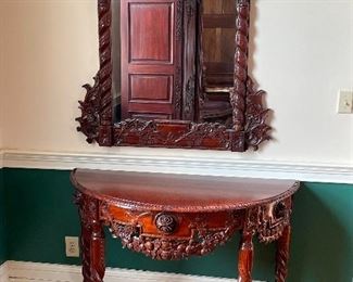 Baroque-inspired semi-circle wooden table and mirror. Mirror: 42"w x 47"h. Table: 48"w x 32"h x 22"d.  Available for pre-sale starting 1/9/23. Text 615-854-8535 for more information and/or to arrange a time to view.