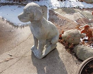 A large cement dog statue retriever