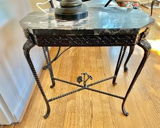 Vintage iron accent table with marble top and floral base