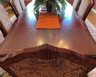 Long Dining Room table with 10 upholstered chairs.