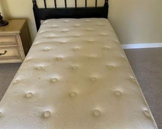 Twin bed with mattress.