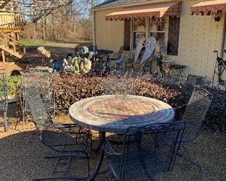 Iron chairs; table with heavy "stone/tile" top