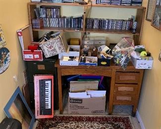 CDs, oak desk, nice rug, small key board, office supplies -to much random stuff!