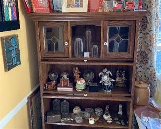 Book case with cups and saucers, china boxes, music boxes, snow globes, glass domes, Christmas frames