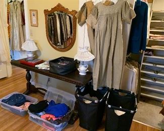 More bins of women’s clothing, embroidered dresses from the mission field, library table, Oak mirror, pair of lamps